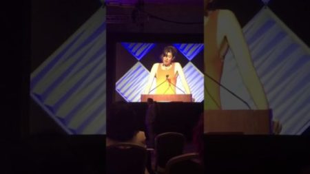 Alida Pepper giving a speech at a podium
